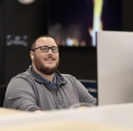 CDS team member smiling while working on a computer